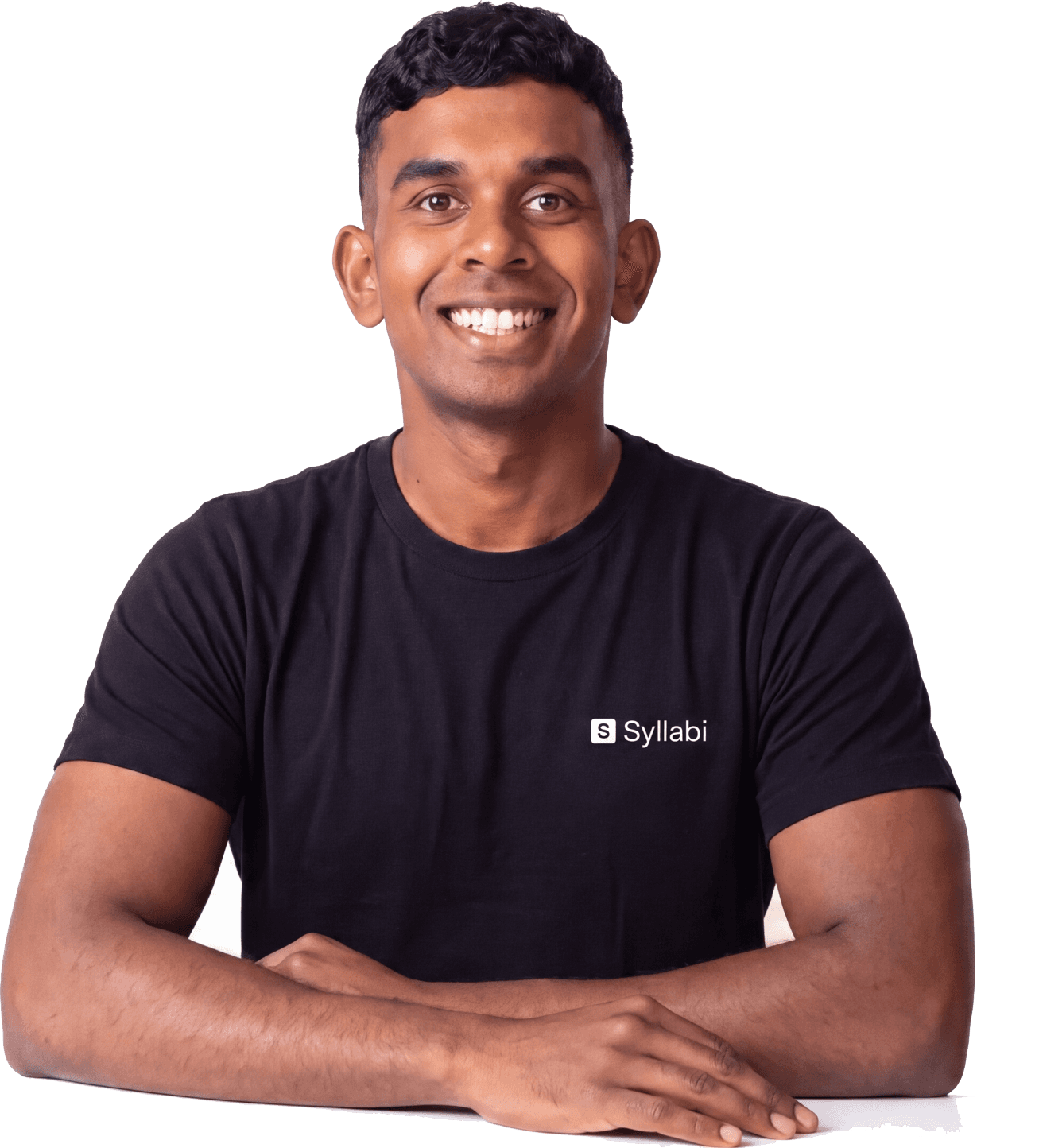Nikhil, a Syllabi mentor, smiling with his arms resting in front of him